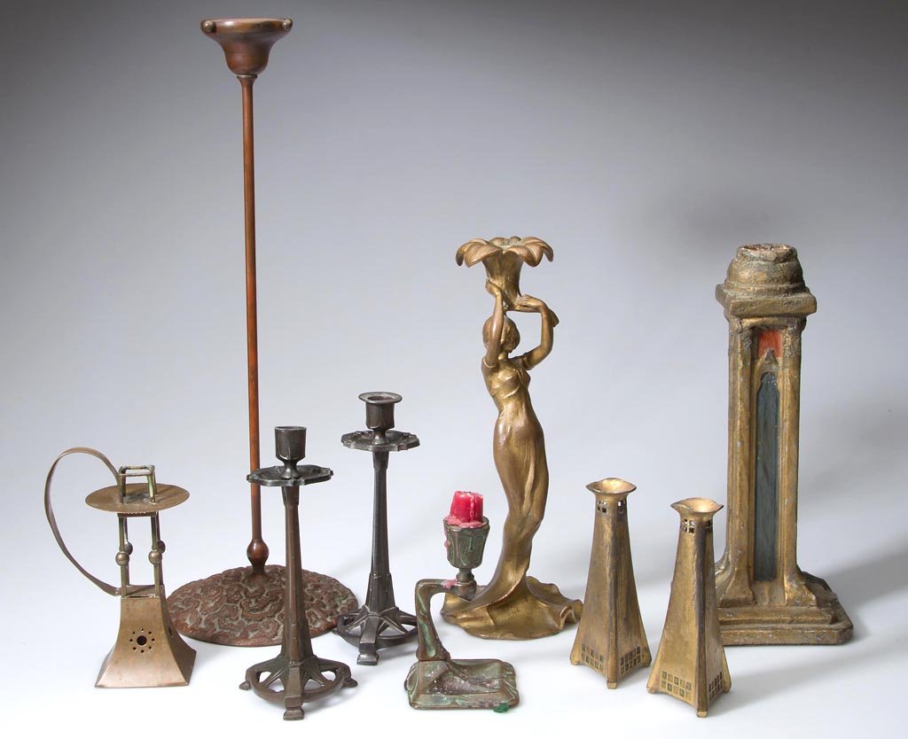 ASSORTED ART NOUVEAU AND ARTS & CRAFTS CANDLESTICKS,: ASSORTED ART NOUVEAU AND ARTS & CRAFTS CANDLESTICKS, LOT OF NINE, including bronze, white metal, brass, and wood. 20th century. 5" to 18 1/4" H. Provenance: Collection of the late Margaret "Maggie" an