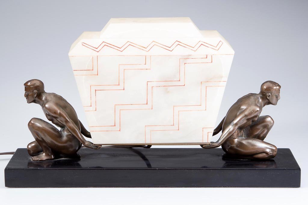 ART DECO FIGURAL LAMP: ART DECO FIGURAL LAMP, featuring two white metal nude men supporting the alabaster shade, all on a black marble base. First quarter 20th century. 8 3/4" H, 15 1/2" L. Provenance: Collection of the lat
