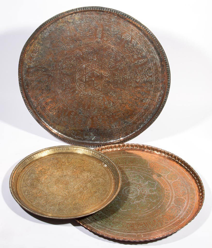 MIDDLE EASTERN / PERSIAN COPPER AND BRASS LARGE TRAYS,: MIDDLE EASTERN / PERSIAN COPPER AND BRASS LARGE TRAYS, LOT OF THREE, each of circular form with elaborate ornamentation. 19th and/or 20th century. 19" to 28" D. Provenance: Property of a Lexington, Vi