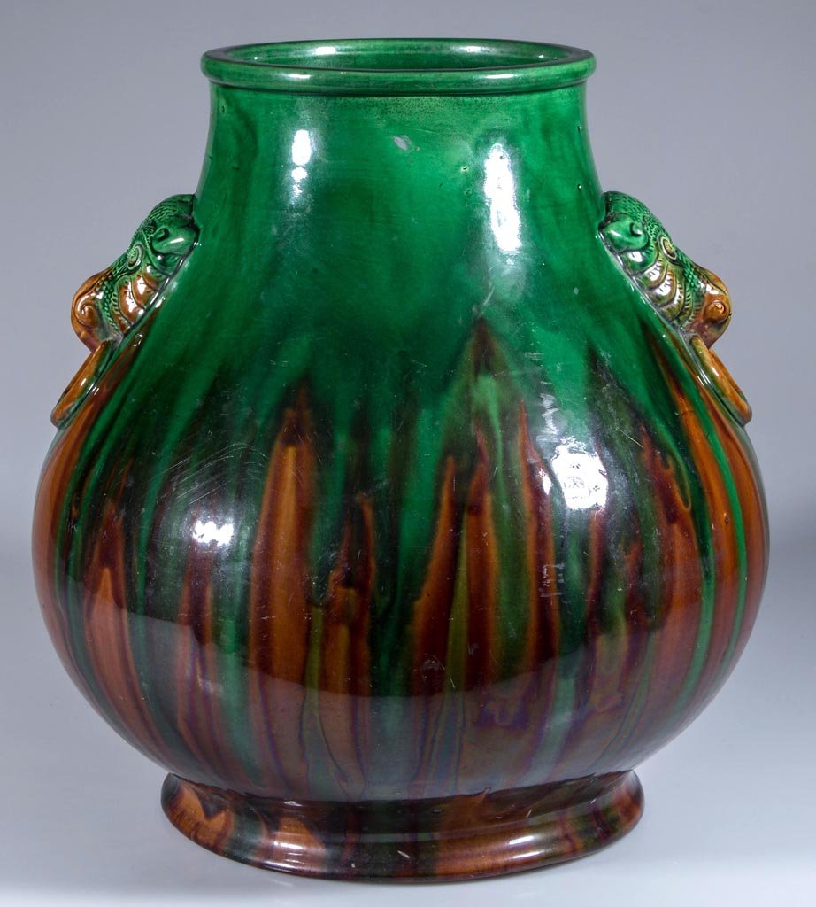 CHINESE EARTHENWARE SANCAI-GLAZED VASE OR PLANTER: CHINESE EARTHENWARE SANCAI-GLAZED VASE OR PLANTER, monkey-head faux handles to the sides, possibly for the Indian or Indonesian market. 20th century. 13 3/4" HOA.