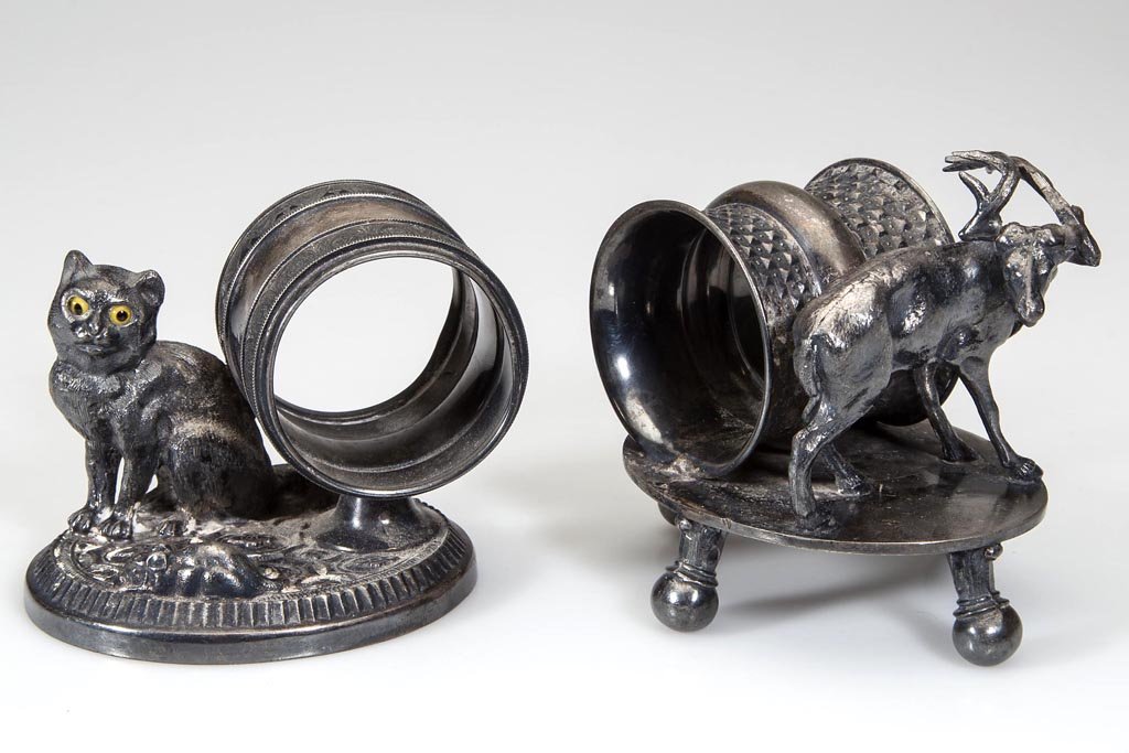 AMERICAN VICTORIAN QUADRUPLE-PLATE FIGURAL NAPKIN: AMERICAN VICTORIAN QUADRUPLE-PLATE FIGURAL NAPKIN RINGS, LOT OF TWO, depicting a seated cat with original yellow eyes watching a mouse, marked for Rogers & Bro., #4337, and a standing stag marked for 