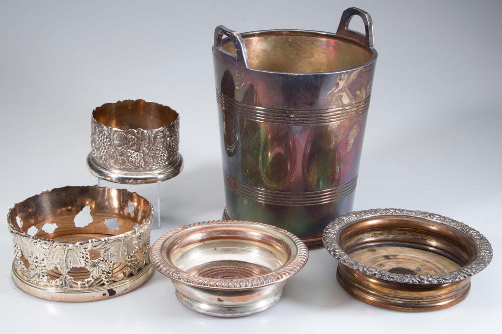 ASSORTED SILVER-PLATE WINE ARTICLES, LOT OF FIVE: ASSORTED SILVER-PLATE WINE ARTICLES, LOT OF FIVE, comprising an ice bucket and four bottle coasters, each with a wooden bottom. 19th and 20th century. 3 1/2" to 6 1/2" D. Provenance: Collection of the