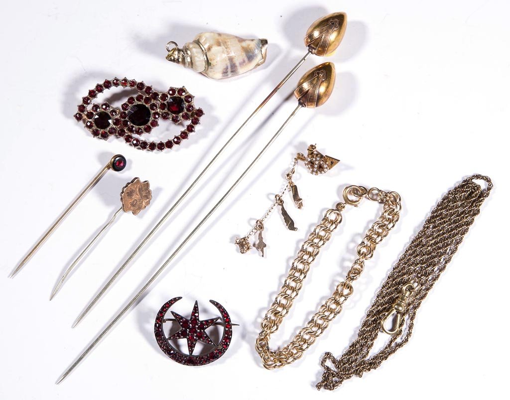 VICTORIAN AND RELATED JEWELRY, LOT OF TEN PIECES: VICTORIAN AND RELATED JEWELRY, LOT OF TEN PIECES, including two hatpins, two garnet broaches, and a sea shell pendant. Late 19th and 20th century. Hatpins 6 1/2" L. Provenance: Property of a Page Co.,
