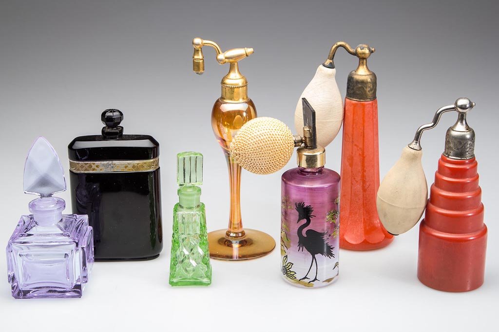 ASSORTED COLORED GLASS ATOMIZERS AND PERFUME BOTTLES,: ASSORTED COLORED GLASS ATOMIZERS AND PERFUME BOTTLES, LOT OF SEVEN, including a square Alexandrite example, one with enameled decoration, a green example marked for Occupied Japan, and a black example