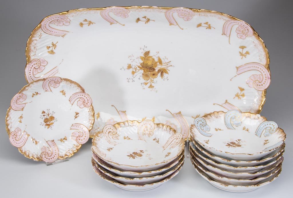 CHARLES AHRENFELDT, LIMOGES, FRANCE PORCELAIN 12-PIECE: CHARLES AHRENFELDT, LIMOGES, FRANCE PORCELAIN 12-PIECE ICE CREAM SET, white ground with pink and light blue highlights, gilt decoration, comprising a master bowl and eleven individual bowls. Each with