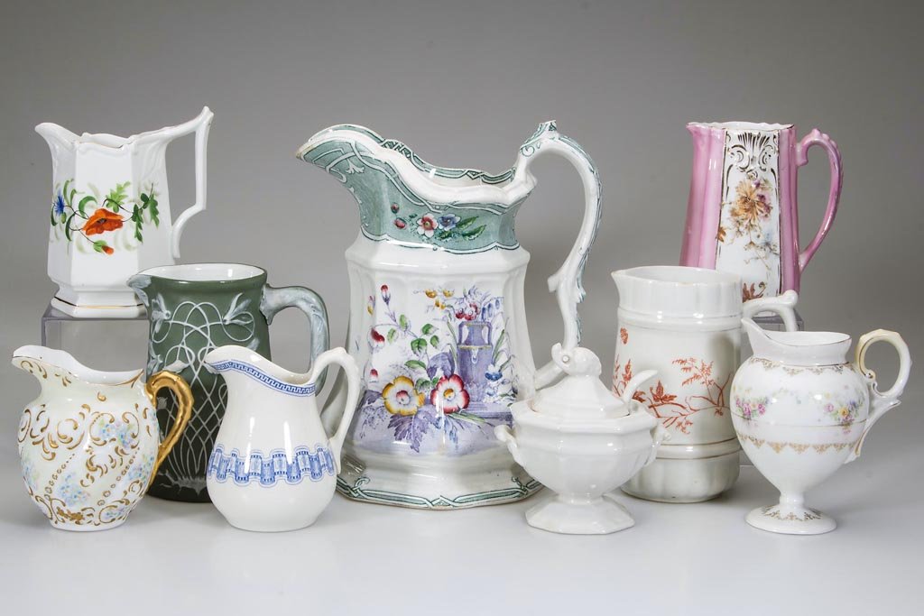 IRONSTONE AND PORCELAIN PITCHERS, LOT OF EIGHT: IRONSTONE AND PORCELAIN PITCHERS, LOT OF EIGHT, including an ironstone Livesley & Powell Co. pitcher with "Indian" transfer pattern decoration, base with purple maker's mark; four examples with floral