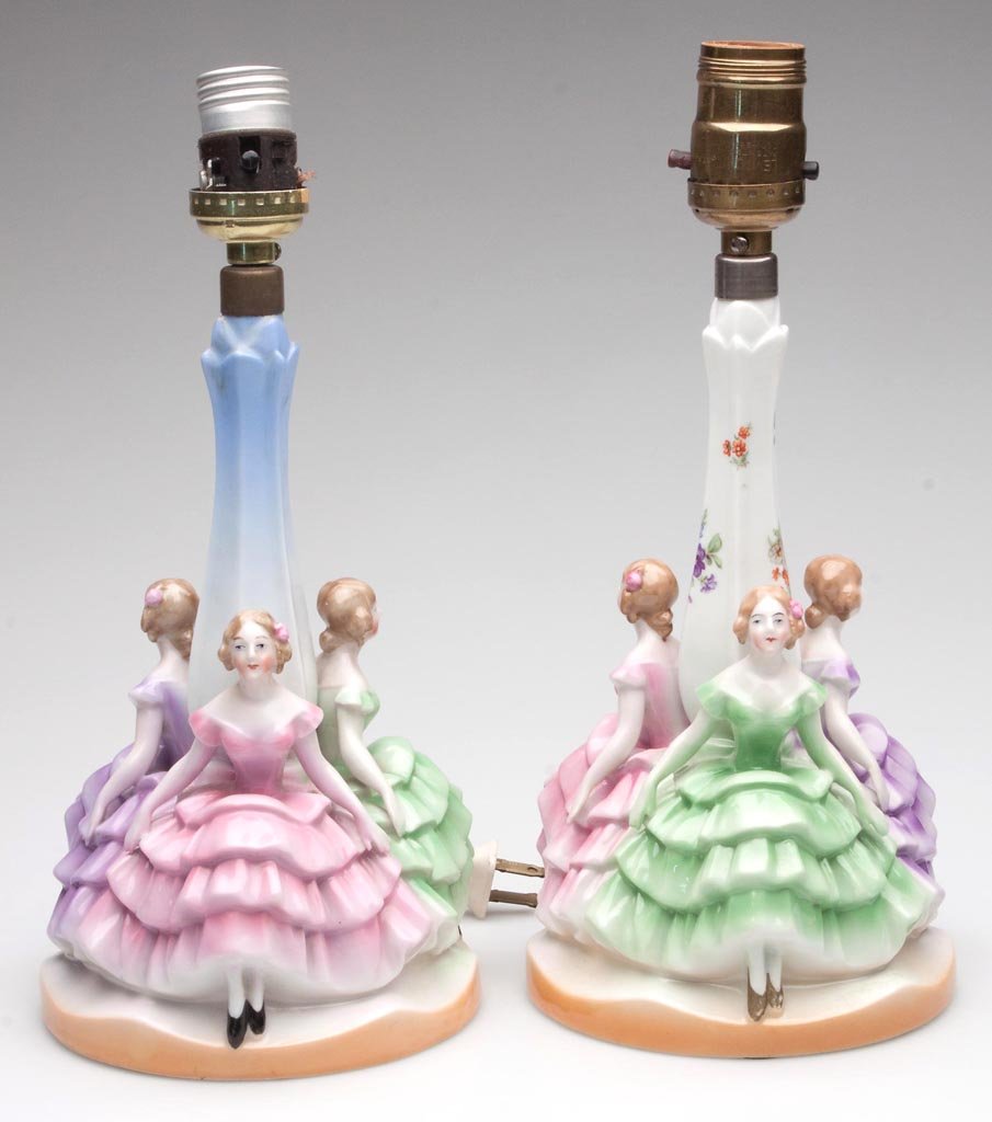 BAVARIAN CHINA FIGURAL BEDROOM LAMPS, LOT OF TWO: BAVARIAN CHINA FIGURAL BEDROOM LAMPS, LOT OF TWO, each featuring three seated ladies encircling stem comprising a green, pink, and a purple example, one stem with blue shading and other with floral po