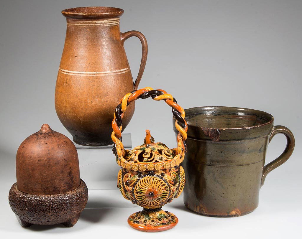 ASSORTED DECORATIVE AND DOMESTIC POTTERY ARTICLES, LOT: ASSORTED DECORATIVE AND DOMESTIC POTTERY ARTICLES, LOT OF FOUR, including an earthenware pitcher with interior lead glazing and an unglazed acorn-form container with removable cap. 19th and 20th centu