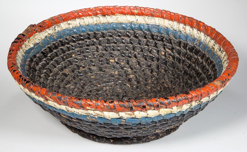 AMERICAN WOVEN-COIL BASKET: AMERICAN WOVEN-COIL BASKET, rye straw and white oak splint, wide circular form with footed base. Red, white, and blue paint likely added in the 1920s or 1930s. Fourth quarter 19th century. 4" HOA, 12