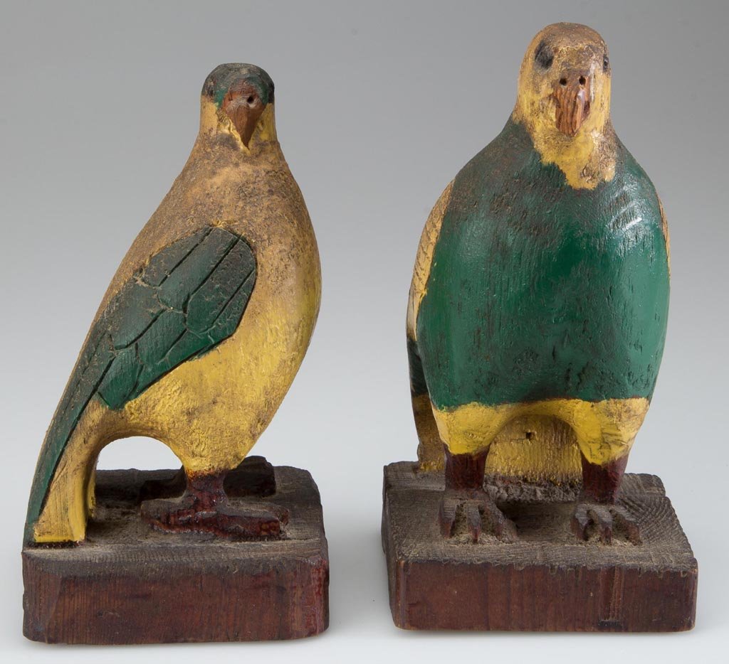 PAIR OF BRUCE A. BARRETT (CUMBERLAND CO., PENNSYLVANIA,: PAIR OF BRUCE A. BARRETT (CUMBERLAND CO., PENNSYLVANIA, 1905-1978) FOLK ART CARVED AND PAINTED BIRD FIGURES, yellow pine, each parrot-like form with incised feather designs. Original green- and yellow