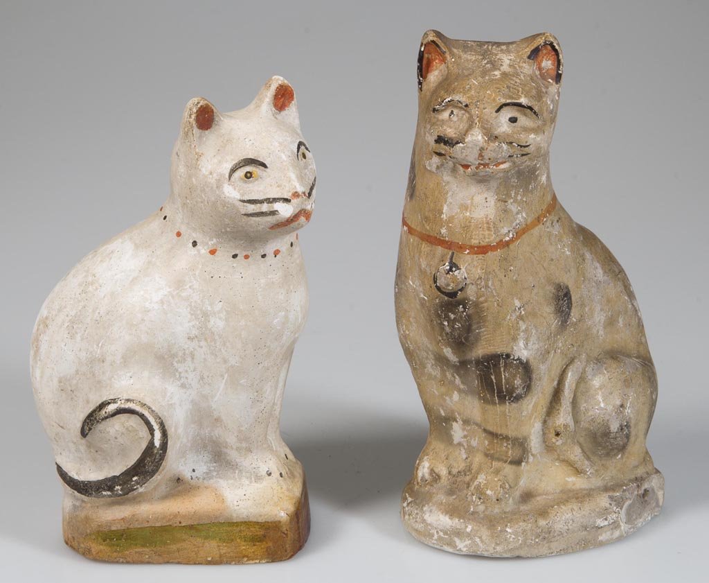 CHALKWARE CAT FIGURES, LOT OF TWO: CHALKWARE CAT FIGURES, LOT OF TWO, comprising a fine example in white paint with black and red highlights on a green painted base, and another example in light gray paint with black and red highlights