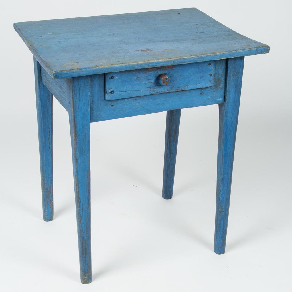 AMERICAN COUNTRY PAINTED WALNUT AND POPLAR ONE-DRAWER: AMERICAN COUNTRY PAINTED WALNUT AND POPLAR ONE-DRAWER STAND TABLE, the overhanging top above a single drawer and raised on square tapered legs with chamfered edges. Blue-painted surface. Circa 1850. 2