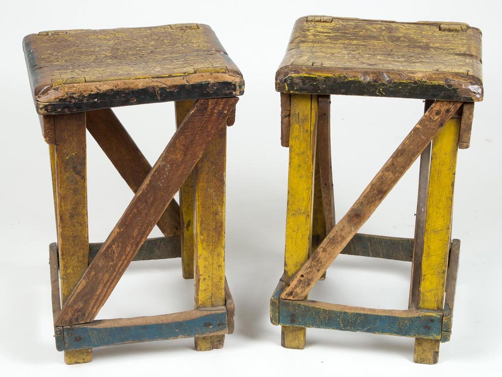 PAIR OF SOUTHERN PRIMITIVE PAINTED STOOLS: PAIR OF SOUTHERN PRIMITIVE PAINTED STOOLS, each solid seat raised on square legs and joined by nailed stretchers. Old yellow- and blue-painted surfaces. Originally from a country store in Alabama. Cir