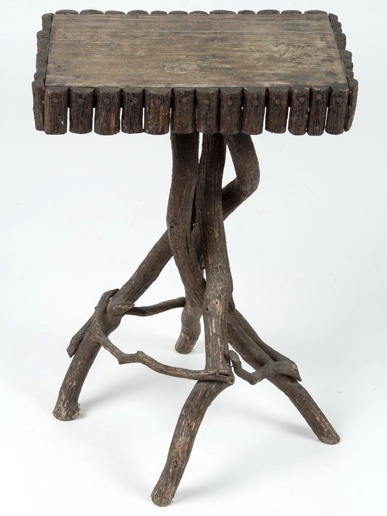 AMERICAN RUSTIC TWIG STAND: AMERICAN RUSTIC TWIG STAND, the rectangular top with applied edge elements raised on a stick-form tripodal base joined by nailed stretchers. Old worn natural surface. Circa 1910-1930. 24" H, 10 1/2" x