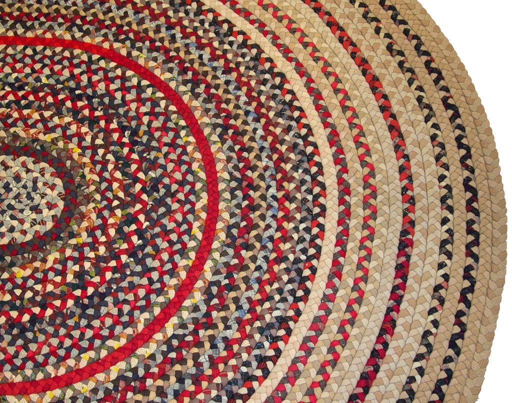 AMERICAN WOVEN BRAIDED ROOM-SIZE RUG: AMERICAN WOVEN BRAIDED ROOM-SIZE RUG, multi-color oval form. Second half 20th century. 7' 1" x 5' 4". Provenance: Collection of the late John and Lil Palmer, Purcellville, VA.