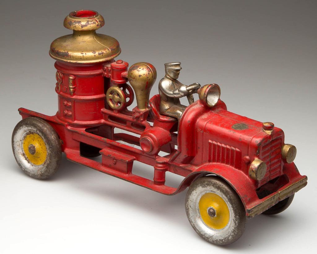 HUBLEY CAST-IRON FIRE PUMPER TOY: HUBLEY CAST-IRON FIRE PUMPER TOY, nickel driver, label on front hood. Original red and gold paint. Circa 1920-1930. 11" LOA. Provenance: Collection of the late John and Lil Palmer, Purcellville, VA.
