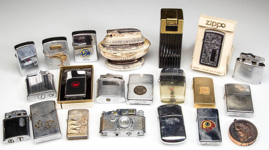 ASSORTED VINTAGE LIGHTERS, LOT OF 21: ASSORTED VINTAGE LIGHTERS, LOT OF 21, including an Occupied Japan camera-form, Napoleon medallion-form example, an engraved 1968 Vietnam War used, one sterling, several Zippo, and one Chase. 20th cent