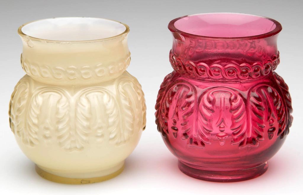 LEAF UMBRELLA TOOTHPICK HOLDERS, LOT OF TWO: LEAF UMBRELLA TOOTHPICK HOLDERS, LOT OF TWO, comprising a cased cranberry example and a cased Topaz/lemon yellow example. Northwood Glass Co. Circa 1889. 3 1/2" H. Provenance: From the collection of B