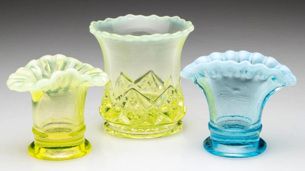 ASSORTED OPALESCENT GLASS TOOTHPICK AND RELATED: ASSORTED OPALESCENT GLASS TOOTHPICK AND RELATED HOLDERS, LOT OF THREE, comprising blue and yellow Fenton mini vases, and a yellow Diamond and Spearhead toothpick holder. 20th century. 2" to 2 3/8" H.