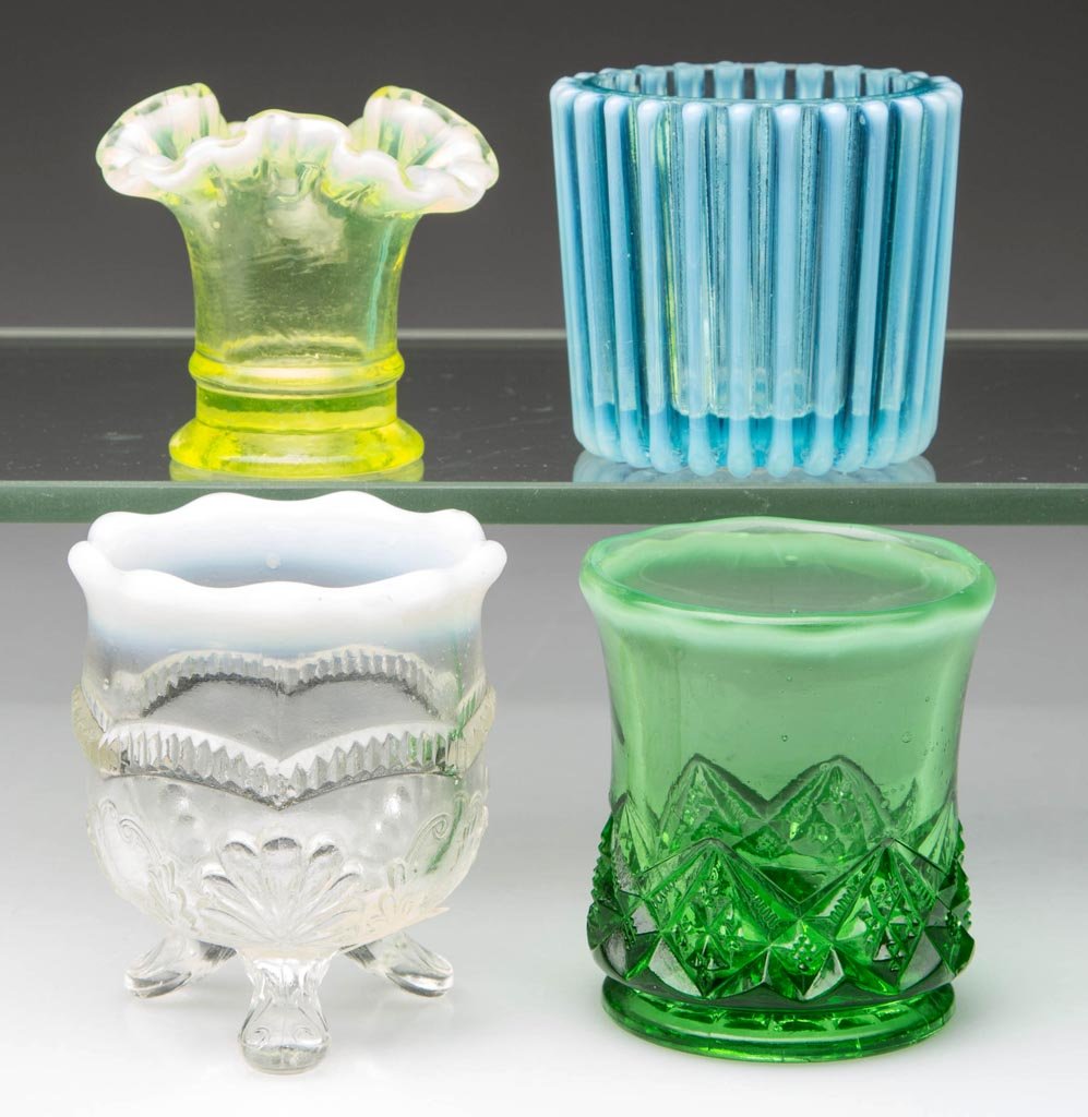 ASSORTED OPALESCENT GLASS TOOTHPICK AND RELATED: ASSORTED OPALESCENT GLASS TOOTHPICK AND RELATED HOLDERS, LOT OF FOUR, comprising a blue Beatty Ribbed, colorless Manila / Wreath and Shell, green Diamond Spearhead, and yellow Fenton mini vase. Late 1