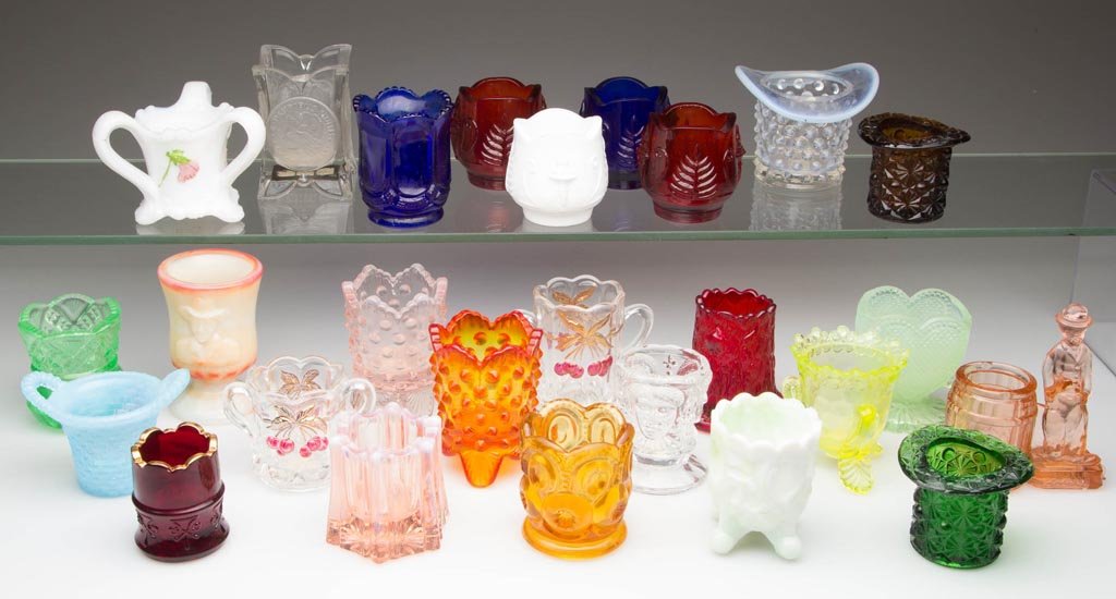 ASSORTED MODERN AND OTHER TOOTHPICK HOLDERS, LOT OF 27: ASSORTED MODERN AND OTHER TOOTHPICK HOLDERS, LOT OF 27, various colors, including several marked for the NTHCS. 20th century. 2 1/4" to 3 1/8" H. Provenance: Collection of Lyle and Doris Davis.