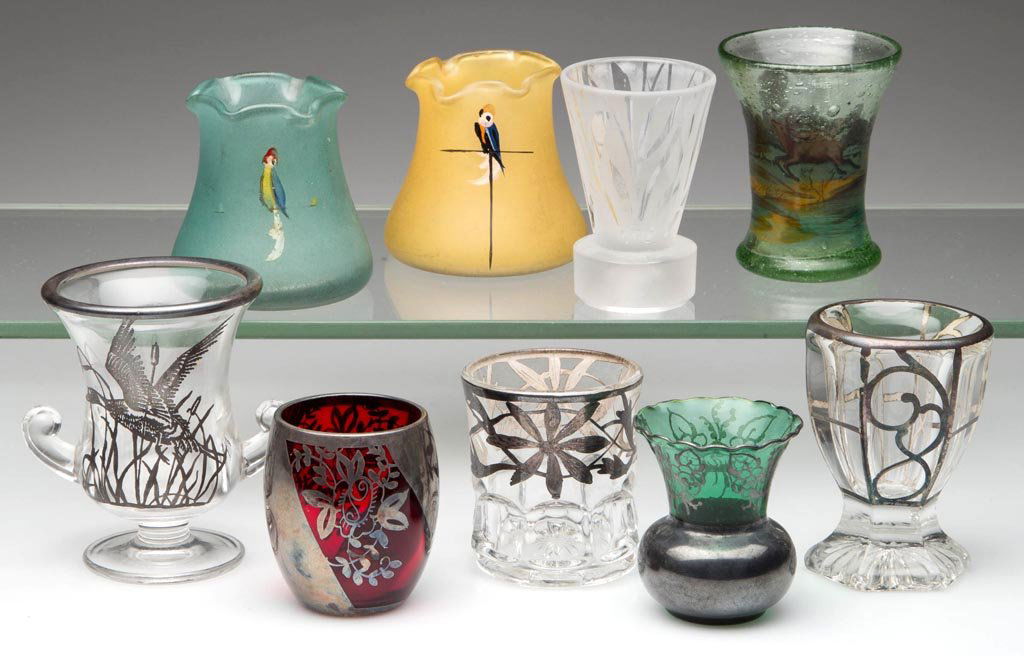 ASSORTED DECORATED GLASS TOOTHPICK / MATCH HOLDERS, LOT: ASSORTED DECORATED GLASS TOOTHPICK / MATCH HOLDERS, LOT OF NINE, including five silver overlay and three enameled examples. 20th century. 2" to 3" H. Provenance: From the collection of Betty and Jim M