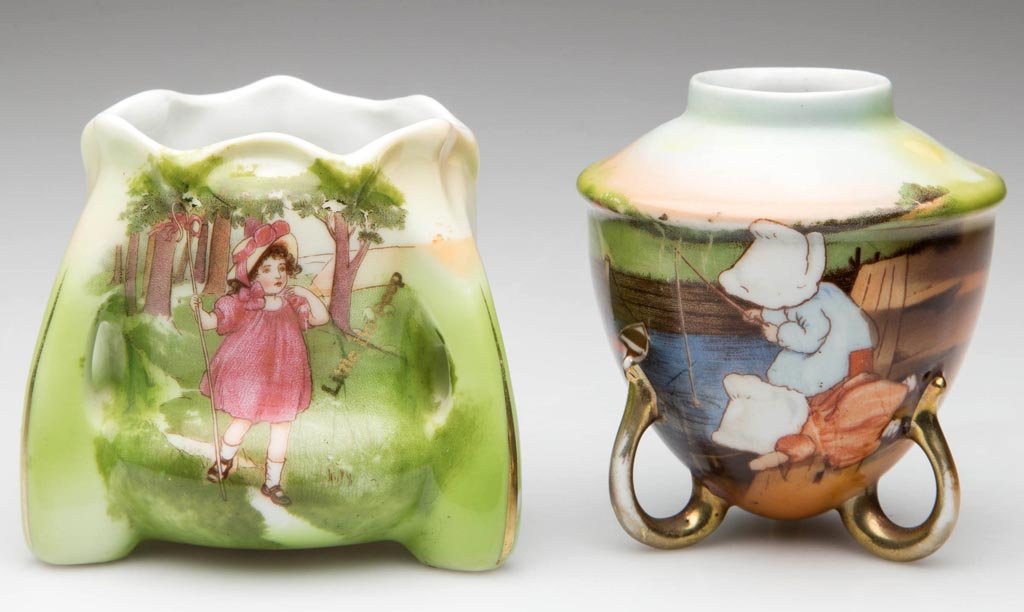 ROYAL BAYREUTH PORCELAIN TOOTHPICK HOLDERS, LOT OF TWO: ROYAL BAYREUTH PORCELAIN TOOTHPICK HOLDERS, LOT OF TWO, one of barrel form, with three pierced supports to the body, painted and printed with " Little Bo-Peep"; and the other of baluster form, on thre