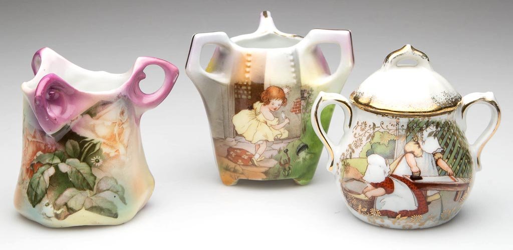 ROYAL BAYREUTH PORCELAIN TOOTHPICK HOLDERS, LOT OF TWO: ROYAL BAYREUTH PORCELAIN TOOTHPICK HOLDERS, LOT OF TWO, with three geometricized ring handles to the rims, one with "Little Miss Muffet", and one with a floral spray. Together with a German "Sun Bonne