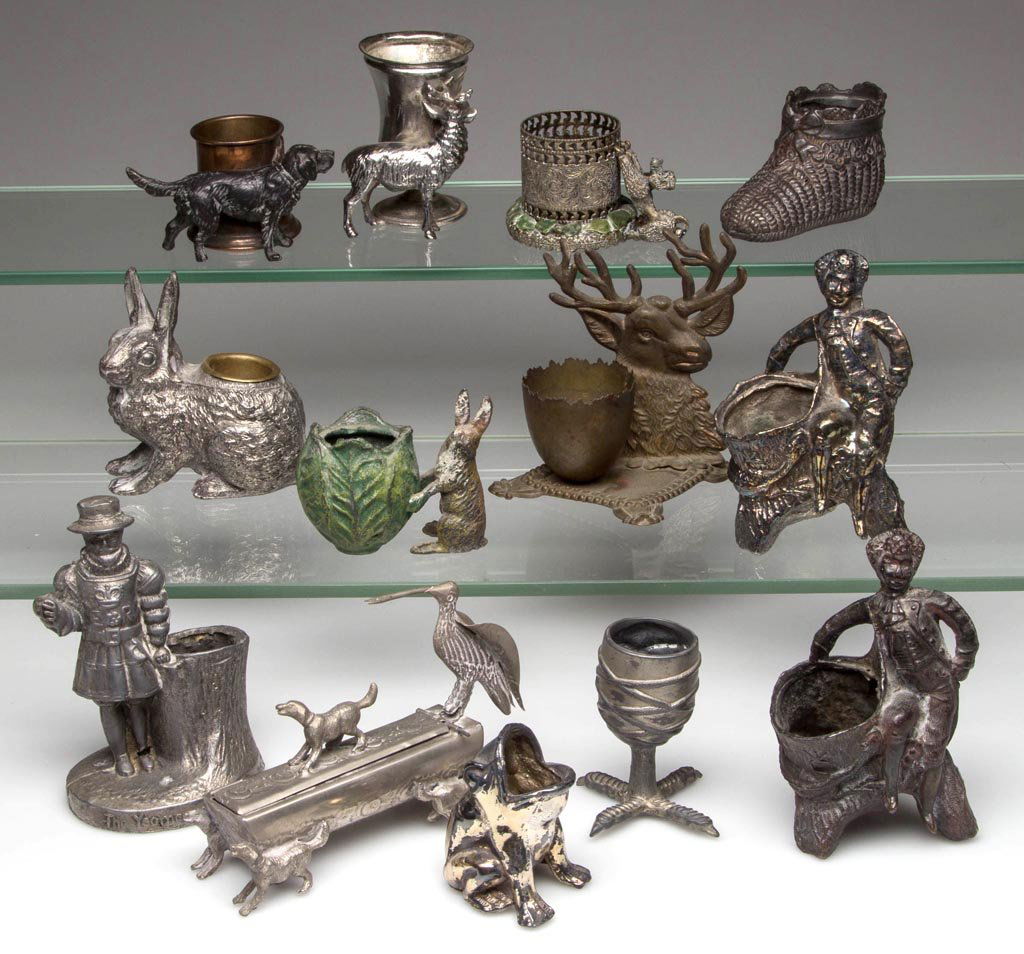 ASSORTED METAL FIGURAL TOOTHPICK HOLDERS, LOT OF 13: ASSORTED METAL FIGURAL TOOTHPICK HOLDERS, LOT OF 13, including silver-plate, brass, and white metal, depicting dogs, rabbits, figures, etc. Fourth quarter 19th/first half 20th century. 1 3/4" to 4 1/4