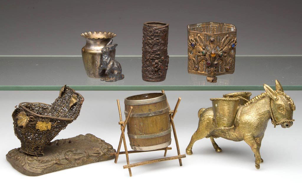 ASSORTED METAL TOOTHPICK HOLDERS, LOT OF SIX: ASSORTED METAL TOOTHPICK HOLDERS, LOT OF SIX, including a pack mule and a barrel on stand. Fourth quarter 19th/early 20th century. 1 3/4" to 3 1/8" H. Provenance: From the collection of Edward Cooke.