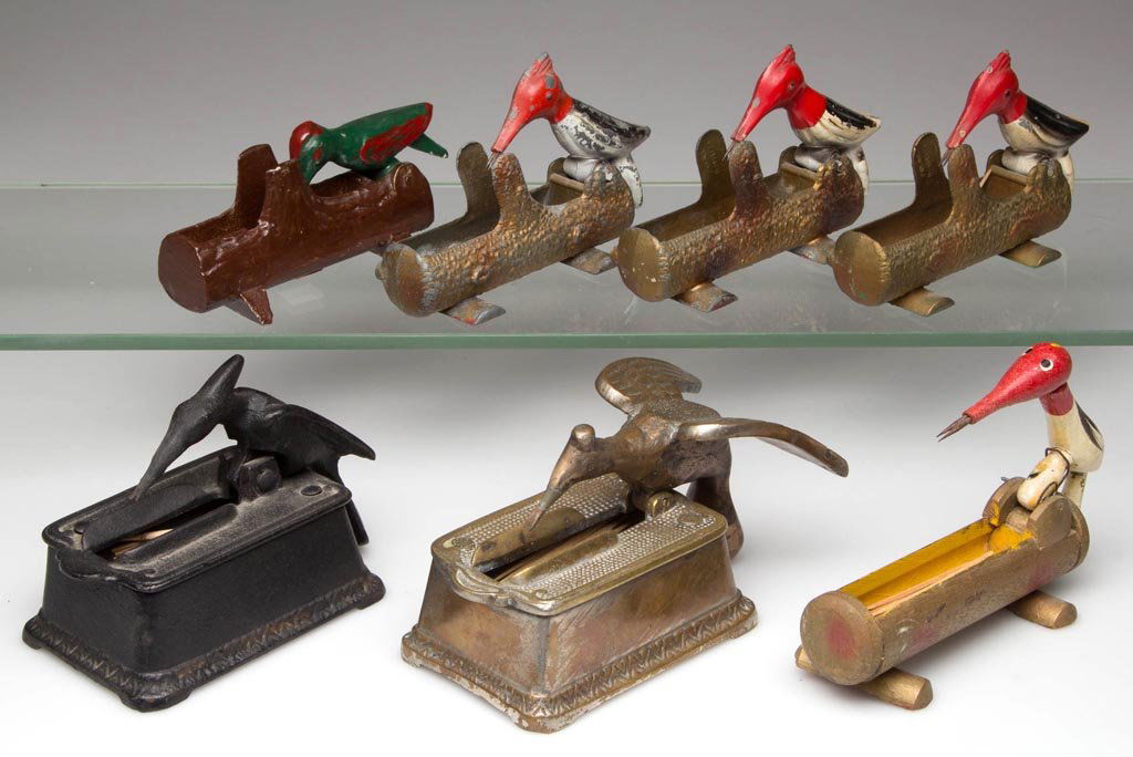 ASSORTED WOODPECKER MECHANICAL TOOTHPICK HOLDERS, LOT: ASSORTED WOODPECKER MECHANICAL TOOTHPICK HOLDERS, LOT OF SEVEN, including cast-iron, cast-brass, white metal, and wood. 20th century. 2 3/4" to 3 1/4" H. Provenance: From the collection of Betty and J