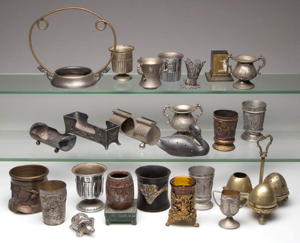 ASSORTED METAL TOOTHPICK HOLDERS, LOT OF 23: ASSORTED METAL TOOTHPICK HOLDERS, LOT OF 23, including brass, pewter, Britannia, and white metal. Together with a silver-plate frame. Twenty-four (24) pieces total. Fourth quarter 19th/first half 20th