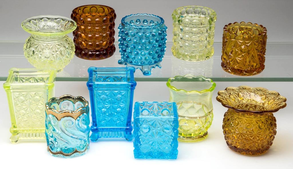 ASSORTED COLORED EAPG TOOTHPICK HOLDERS, LOT OF 11: ASSORTED COLORED EAPG TOOTHPICK HOLDERS, LOT OF 11, including four vaseline (uranium) examples. Late 19th/early 20th century. 2 1/8" to 3" H. Provenance: From the collection of Betty and Jim MaGuire.