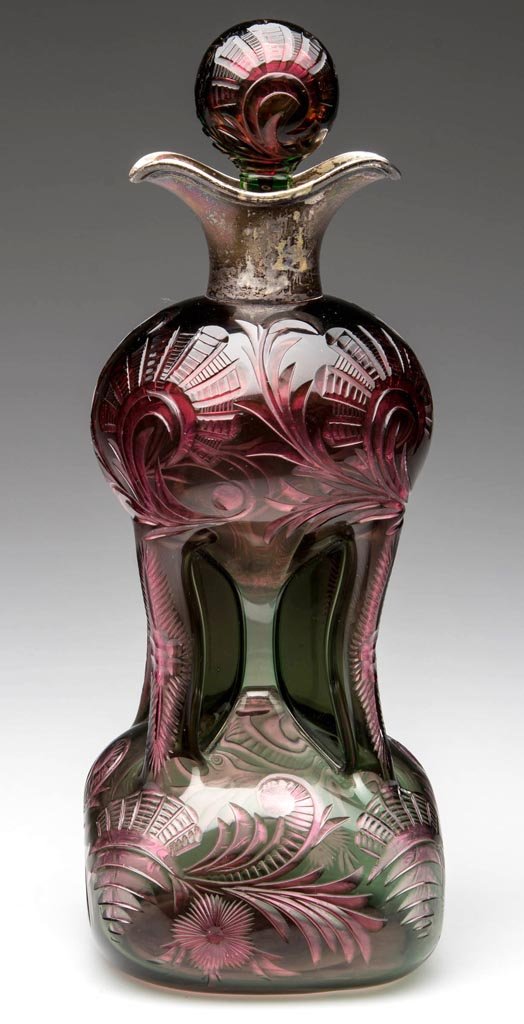 STEVENS AND WILLIAMS TWO-COLOR CUT OVERLAY CORDIAL: STEVENS AND WILLIAMS TWO-COLOR CUT OVERLAY CORDIAL DECANTER, green to rose, square pinched form with Birmingham silver mount marked for 1898, elaborate scroll and floral ornamentation, original teared