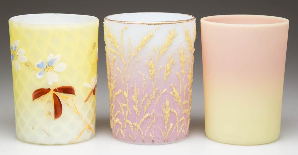 ASSORTED GLASS TUMBLERS, LOT OF THREE: ASSORTED GLASS TUMBLERS, LOT OF THREE, comprising a Burmese, a mauve shaded example with coralline and gilt decoration, and a lemon yellow Phoenix's Diamond air-trap mother-of-pearl satin with polychr