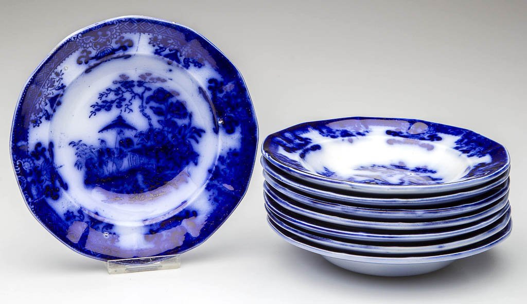 DAVENPORT IRONSTONE POTTERY FLOW BLUE "AMOY" PATTERN: DAVENPORT IRONSTONE POTTERY FLOW BLUE "AMOY" PATTERN SIDE DISHES OR SAUCERS, LOT OF EIGHT, of lightly-molded paneled form, printed with the pattern to the face, under an Asian-influenced geometric and