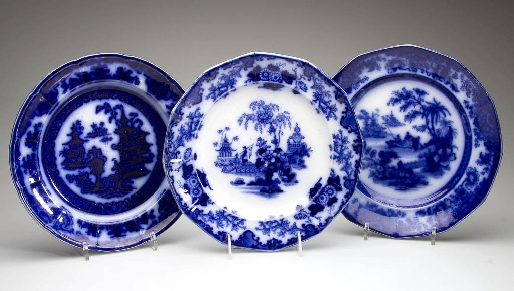 ENGLISH IRONSTONE POTTERY FLOW BLUE PLATES, LOT OF: ENGLISH IRONSTONE POTTERY FLOW BLUE PLATES, LOT OF THREE, comprising Alcock "Scinde" pattern, Hancock's "Tonquin" pattern, and an example of "Temple" pattern, all with lightly-molded rims, printed in