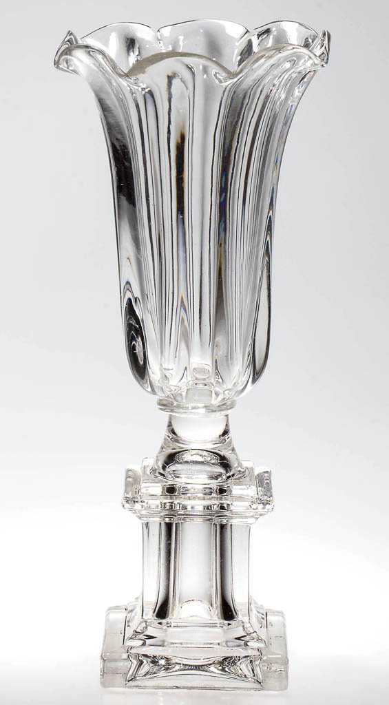 PILLAR-MOLDED AND PRESSED VASE: PILLAR-MOLDED AND PRESSED VASE, colorless, deep conical bowl with eight pronounced ribs and a gauffered eight-petal rim, raised on a square monument base, wafer construction. Factory polished under ba