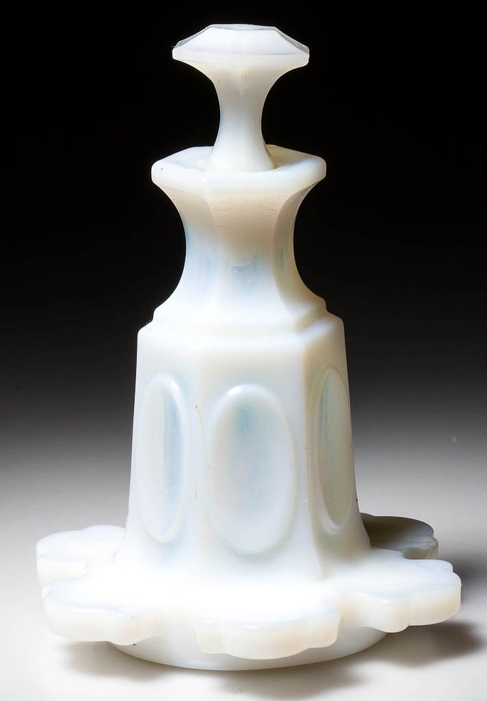 PRESSED ELONGATED LOOP COLOGNE BOTTLE: PRESSED ELONGATED LOOP COLOGNE BOTTLE, deep fiery opalescent, small-size hexagonal form with flanged skirt, cut-and-shut scar under base, original hexagonal mushroom-form stopper. New England Glass Co