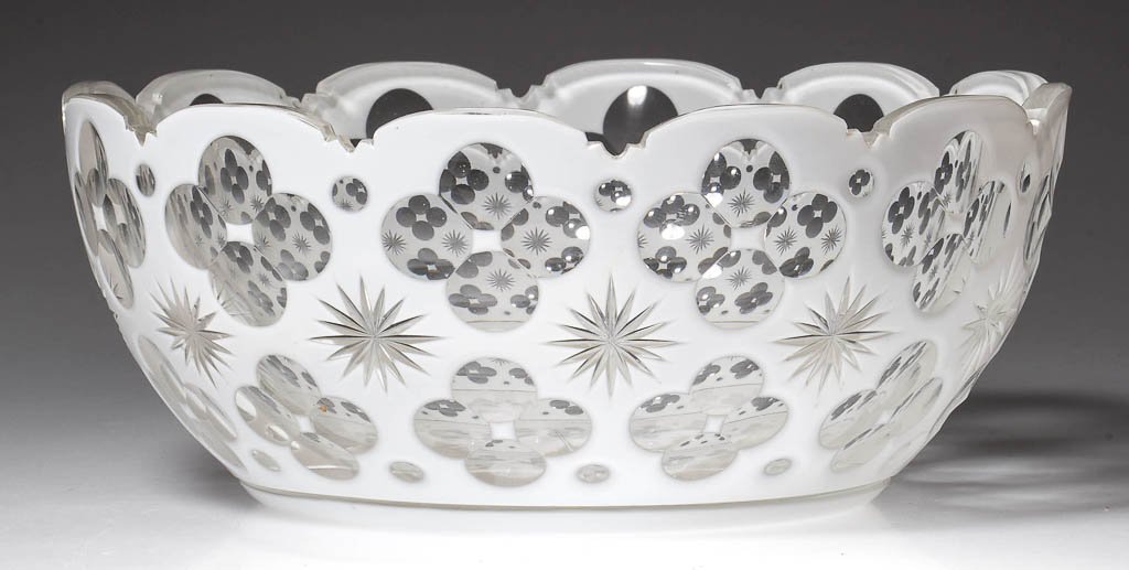 CUT OVERLAY QUATREFOIL AND STAR BOWL: CUT OVERLAY QUATREFOIL AND STAR BOWL, white to colorless, deep form with 12-scallop rim, eight-petal rosette cut in base. Boston & Sandwich Glass Co. and others. Circa 1850-1880. 3 1/2" H, 8 1/2" D. L