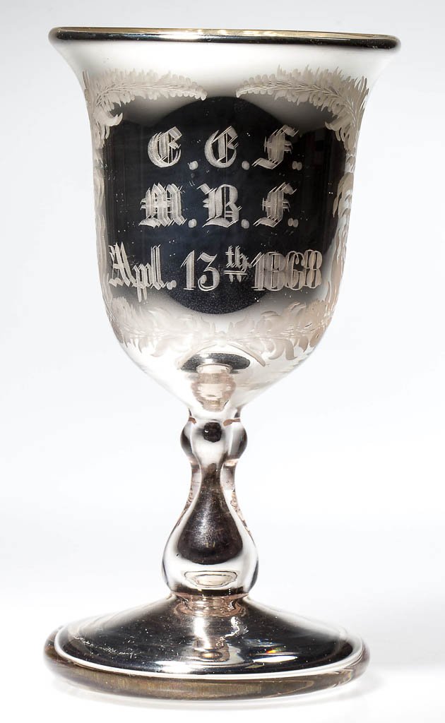 SILVERED / MERCURY GLASS PRESENTATION GOBLET: SILVERED / MERCURY GLASS PRESENTATION GOBLET, finely engraved "G. G. F. / M. B. F. / Apl. 13th 1868" within a foliate wreath, deep bowl with flared rim, raised on a tall baluster-form stem and thick c