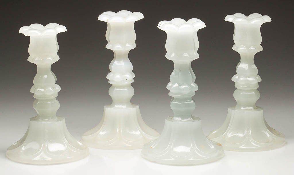 PRESSED PETAL AND LOOP CANDLESTICKS, LOT OF FOUR: PRESSED PETAL AND LOOP CANDLESTICKS, LOT OF FOUR, alabaster/clambroth, one with slight opalescence, each six-petal socket with a hexagonal extension, raised on a hexagonal knop and seven-loop circular