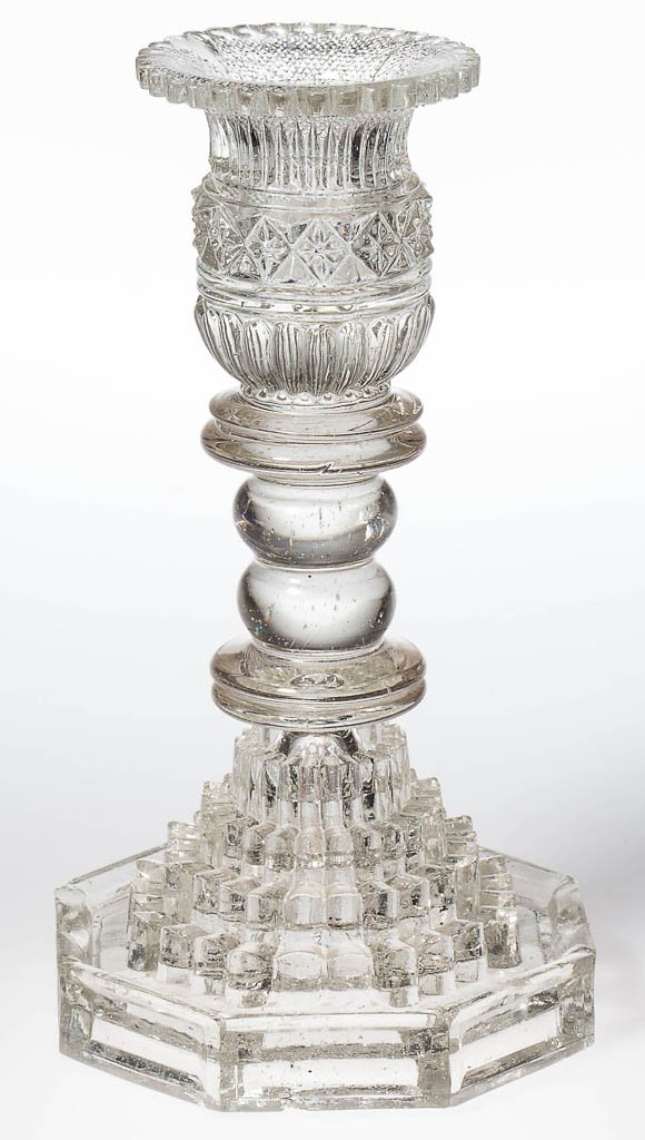 FREE-BLOWN AND PRESSED LACY SOCKET CANDLESTICK: FREE-BLOWN AND PRESSED LACY SOCKET CANDLESTICK, colorless, unrecorded socket with medial star-in-diamond band and 32-scallop rim, raised on a blown double-knop stem, and pressed base comprising four 2