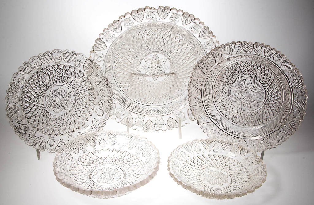 ASSORTED PRESSED HEART PATTERN ARTICLES, LOT OF FIVE: ASSORTED PRESSED HEART PATTERN ARTICLES, LOT OF FIVE, colorless, comprising three plates and two nappies, three with alternating heart and sheaf ornaments and two with alternating heart and lyre ornam