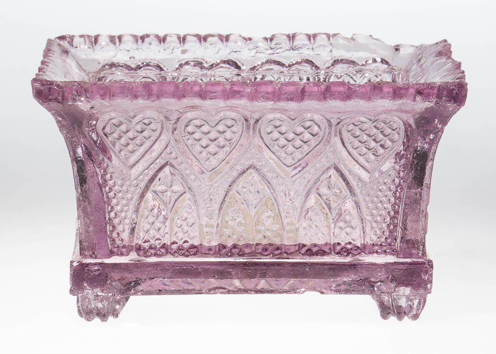 GA-5 GOTHIC ARCH AND HEART PRESSED OPEN SALT: GA-5 GOTHIC ARCH AND HEART PRESSED OPEN SALT, pale amethyst, even scallop rim, raised on four paw feet. Rare. Probably Boston & Sandwich Glass Co. Circa 1835-1845. 1 5/8" H, 2" x 2 7/8". Literature: N