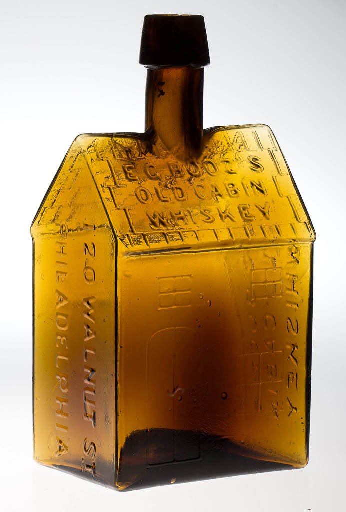 EARLY CLEVENGER BROTHERS BOOZ'S OLD CABIN WHISKEY: EARLY CLEVENGER BROTHERS BOOZ'S OLD CABIN WHISKEY BOTTLE, medium amber, straight-roof variation with applied sloping-collar mouth. Some cork stuck in neck. Clevenger Brothers, New Jersey. Circa 1930. 