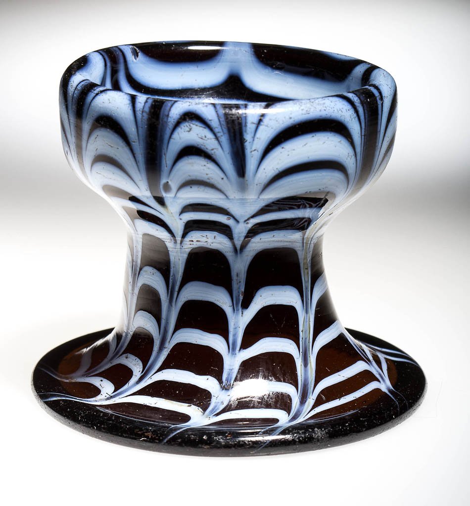 FREE-BLOWN AND DECORATED PEDESTAL OPEN SALT: FREE-BLOWN AND DECORATED PEDESTAL OPEN SALT, deep amber with opal loopings, raised on a drawn funnel base with folded rim, rough pontil mark in base of bowl. First half 19th century. 2 1/2" H, 2 5/8" 