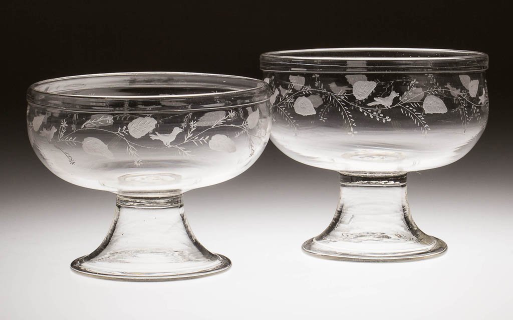 FREE-BLOWN FOOTED BOWLS, NEAR PAIR: FREE-BLOWN FOOTED BOWLS, NEAR PAIR, colorless lead glass, each semi-hemispherical bowl with outward-folded rim, raised on funnel foot with folded rim. Each with later engraved decoration. First half 1