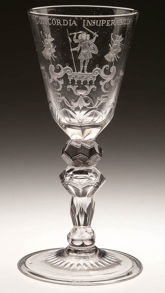 GERMAN FREE-BLOWN, CUT AND ENGRAVED GOBLET: GERMAN FREE-BLOWN, CUT AND ENGRAVED GOBLET, colorless non-lead glass, round funnel bowl featuring a coat of arms with a central depiction of Geryones, the unconquerable three-headed giant inscribed "C