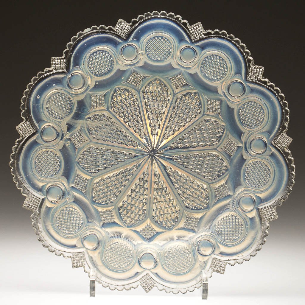 PRESSED ROMAN ROSETTE PLATE: PRESSED ROMAN ROSETTE PLATE, fiery opalescent, rim with 11 large scallops divided into eight small scallops, alternating with a large point filled with tiny diamonds. Boston & Sandwich Glass Co. and p